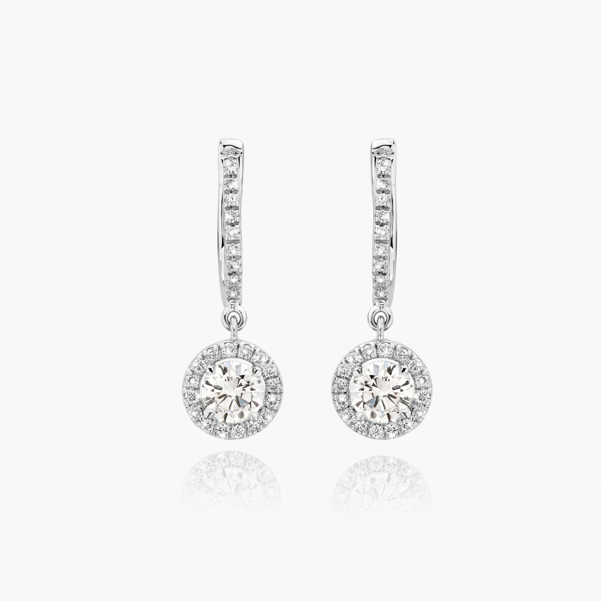 White gold earrings set with diamonds made by Maison De Greef